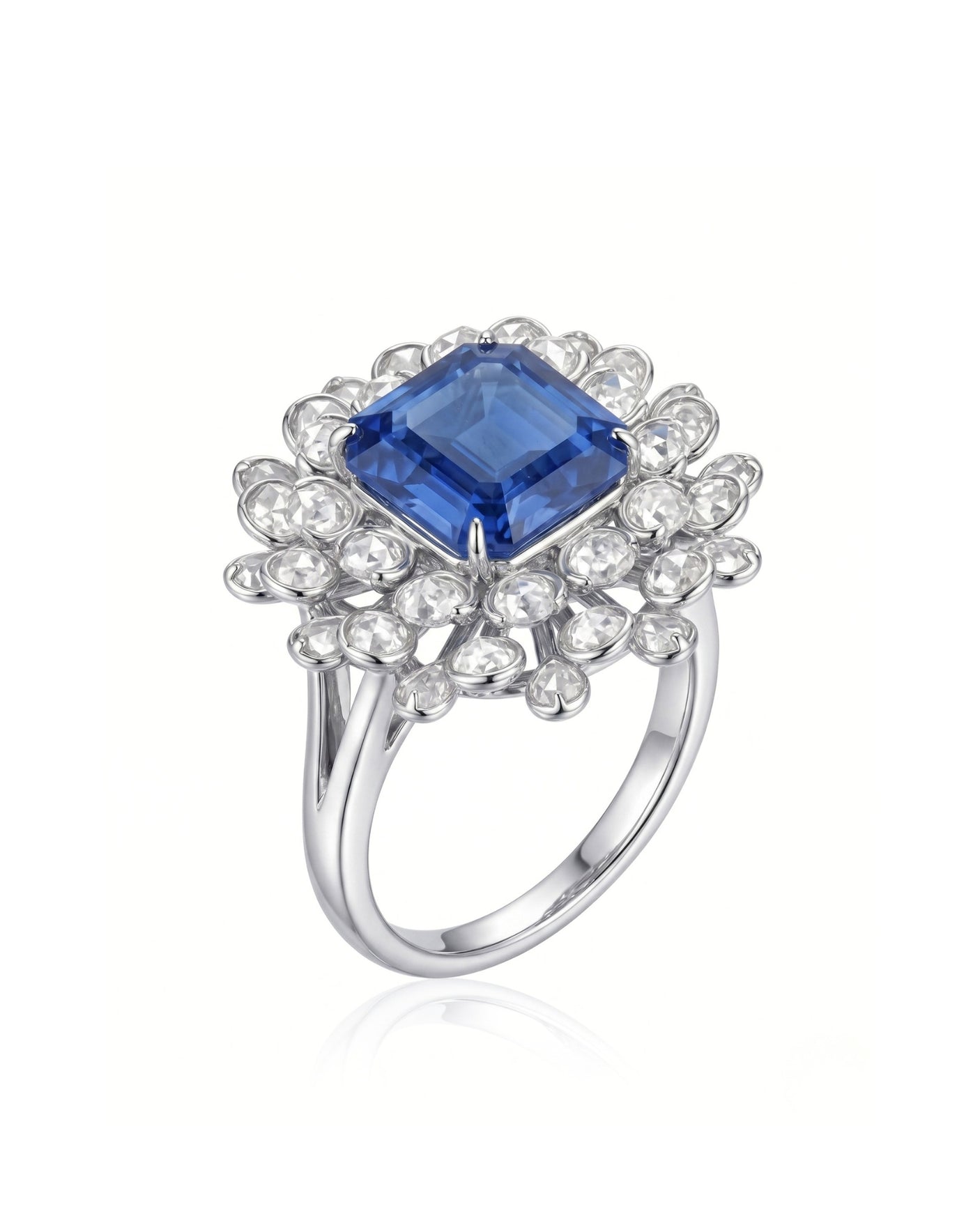 Royal blue sapphire ring with emerald-cut center and diamond floral halo in platinum | SARATTI
