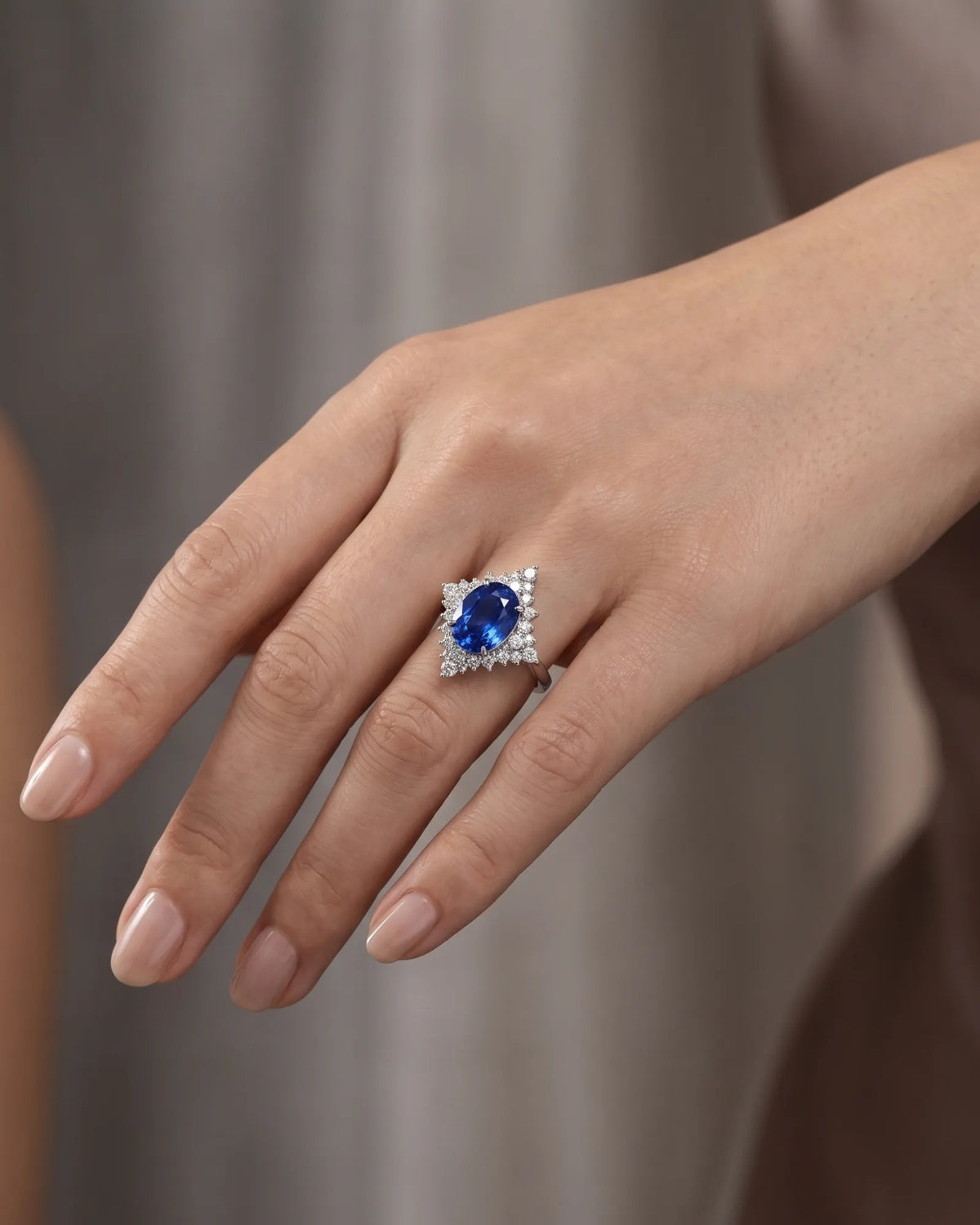 SERAPHINE cornflower blue sapphire diamond ring with oval centre stone and graduated platinum diamond surround - SARATTI