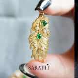 Gold feather brooch with emerald cabochons and diamonds | SARATTI