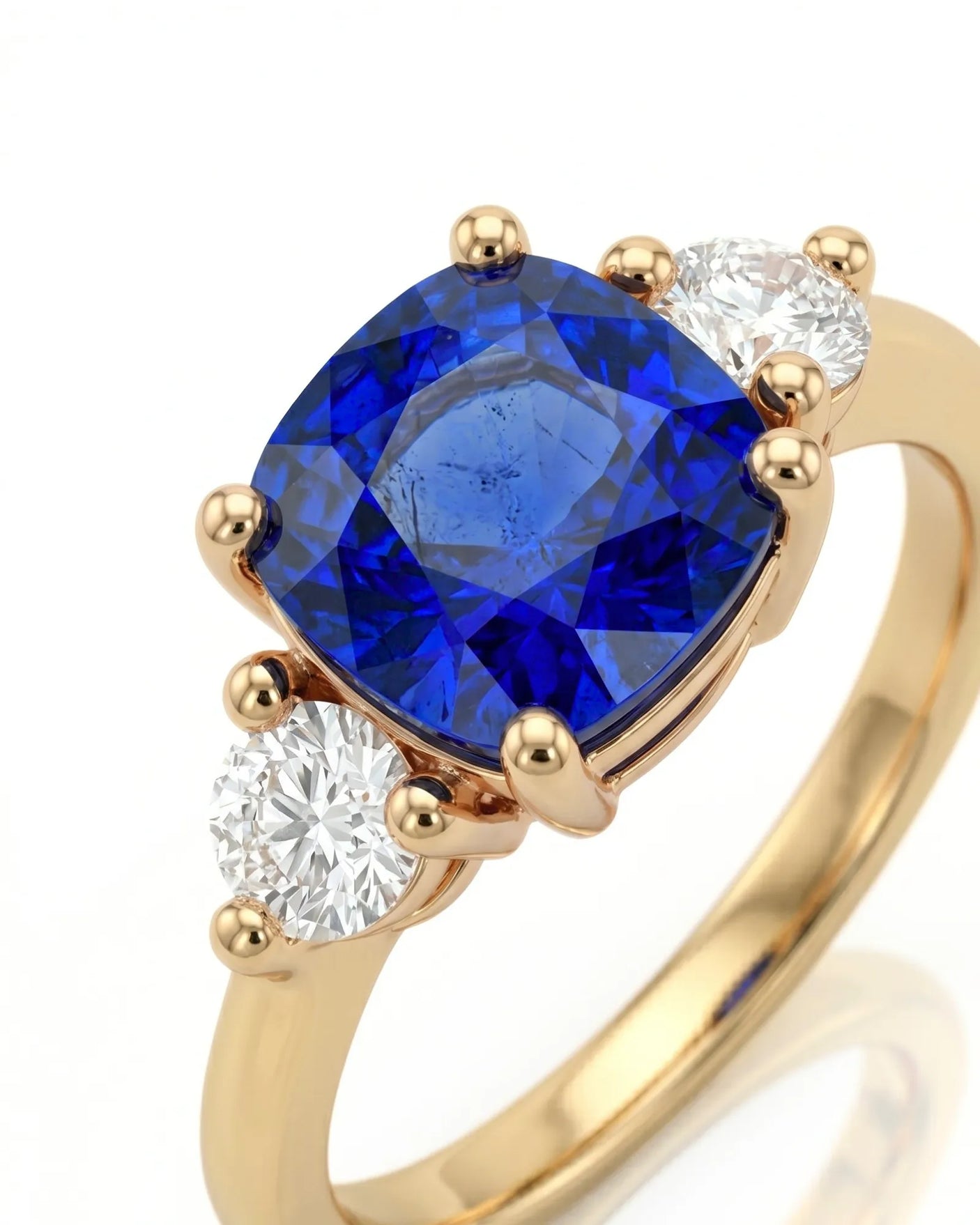Sapphire and diamond engagement ring with classic three-stone design in yellow gold | SARATTI