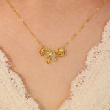 Model Wearing Yellow Gold Ribbon Design 18K Gold Diamond Drop Necklace | Saratti