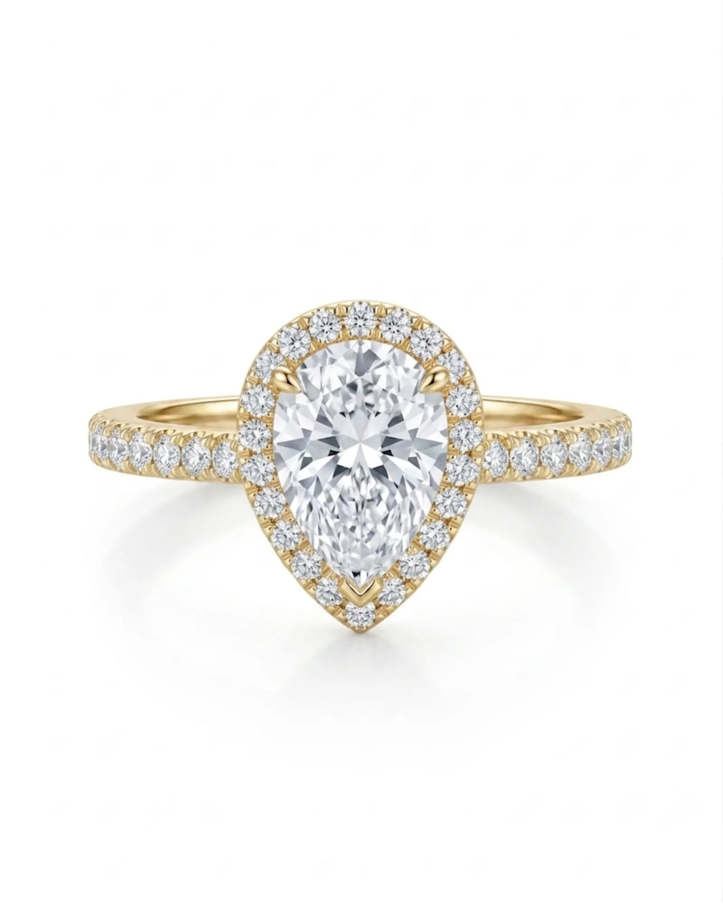 Sculpted teardrop moissanite ring with elevated halo setting crafted in warm 18K yellow gold | SARATTI