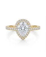 Sculpted teardrop moissanite ring with elevated halo setting crafted in warm 18K yellow gold | SARATTI