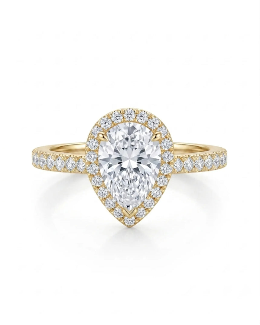 Sculpted teardrop moissanite ring with elevated halo setting crafted in warm 18K yellow gold | SARATTI