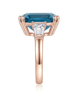 Sculptural blue topaz ring with double-claw corners and geometric diamond sides in 18K rose gold | SARATTI