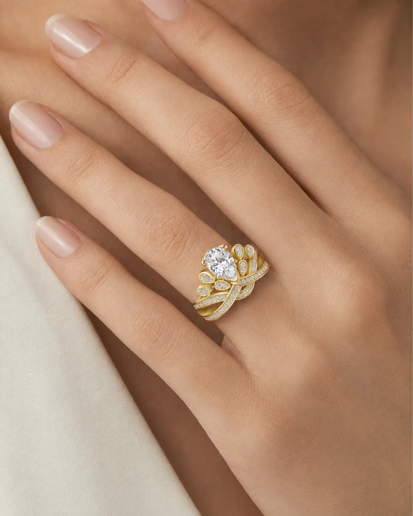 Sculptural crown moissanite ring with pavé ribbons and leaf motifs in warm 18K yellow gold | SARATTI