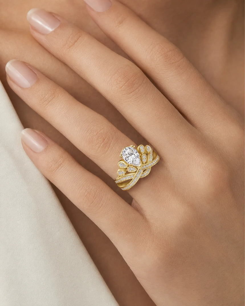 Sculptural crown moissanite ring with pavé ribbons and leaf motifs in warm 18K yellow gold | SARATTI
