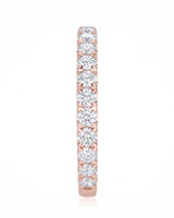 Sculptural infinity wedding ring with intertwined curves and diamond accents in warm 18K rose gold | SARATTI