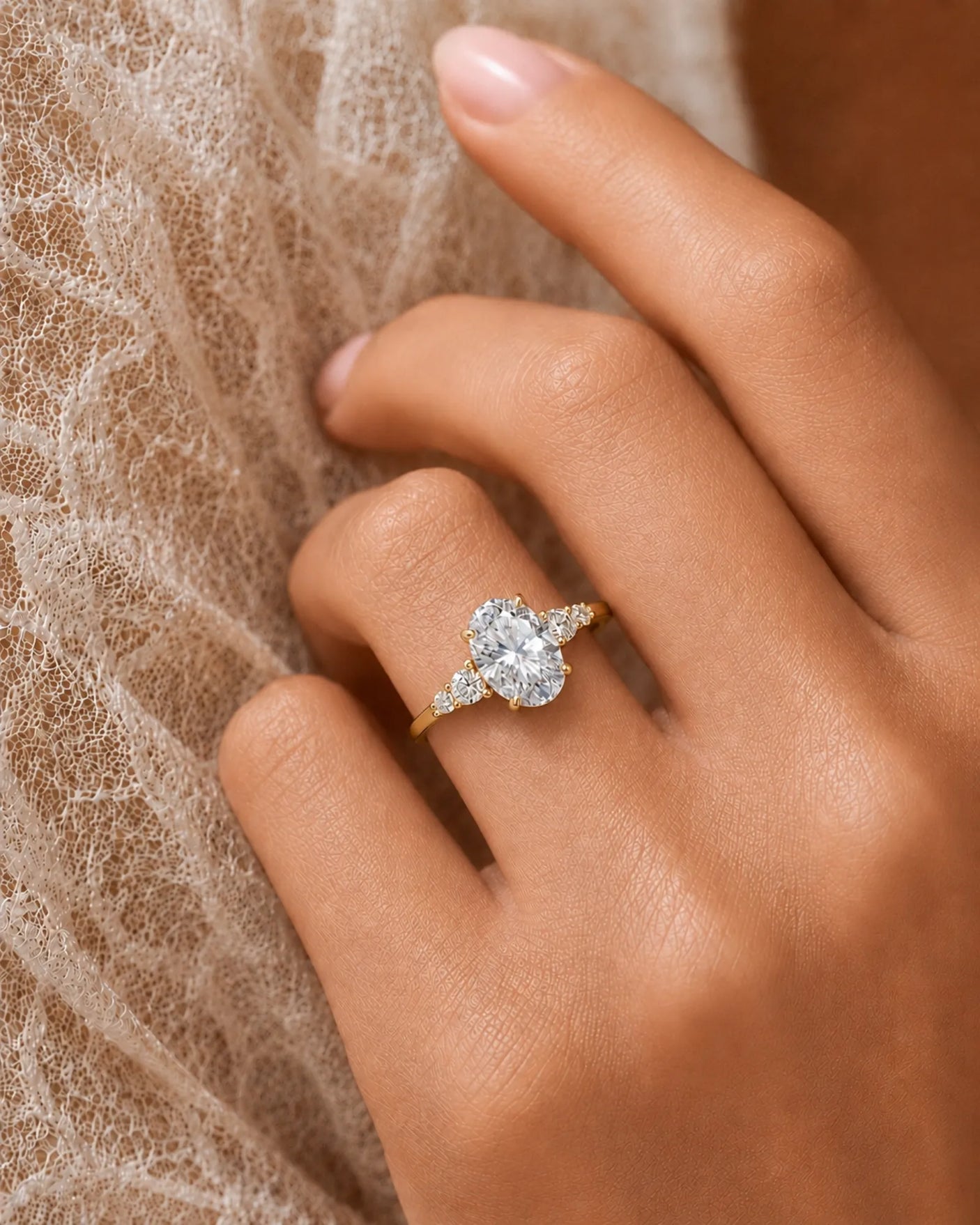 Sculptural oval diamond ring with flowing round side stones and high-polish 18K yellow gold band | SARATTI