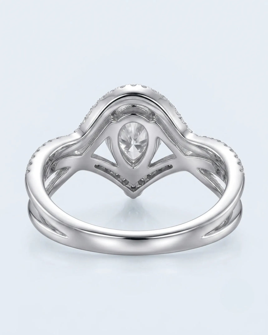 Sculptural pear moissanite engagement ring with split shank and curved wedding band in 18K white gold | SARATTI