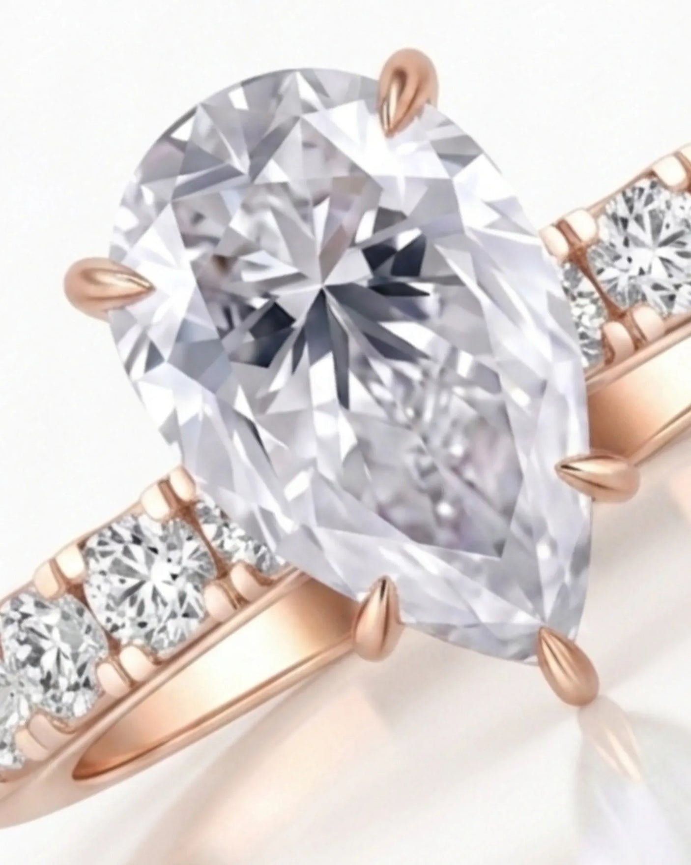 Sculptural pear moissanite ring with hidden halo and accented shoulders in polished 18K rose gold - SARATTI