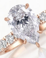Sculptural pear moissanite ring with hidden halo and accented shoulders in polished 18K rose gold - SARATTI