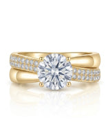 Sculptural split shank moissanite ring with polished ribbon and pavé detailing in 18K yellow gold | SARATTI