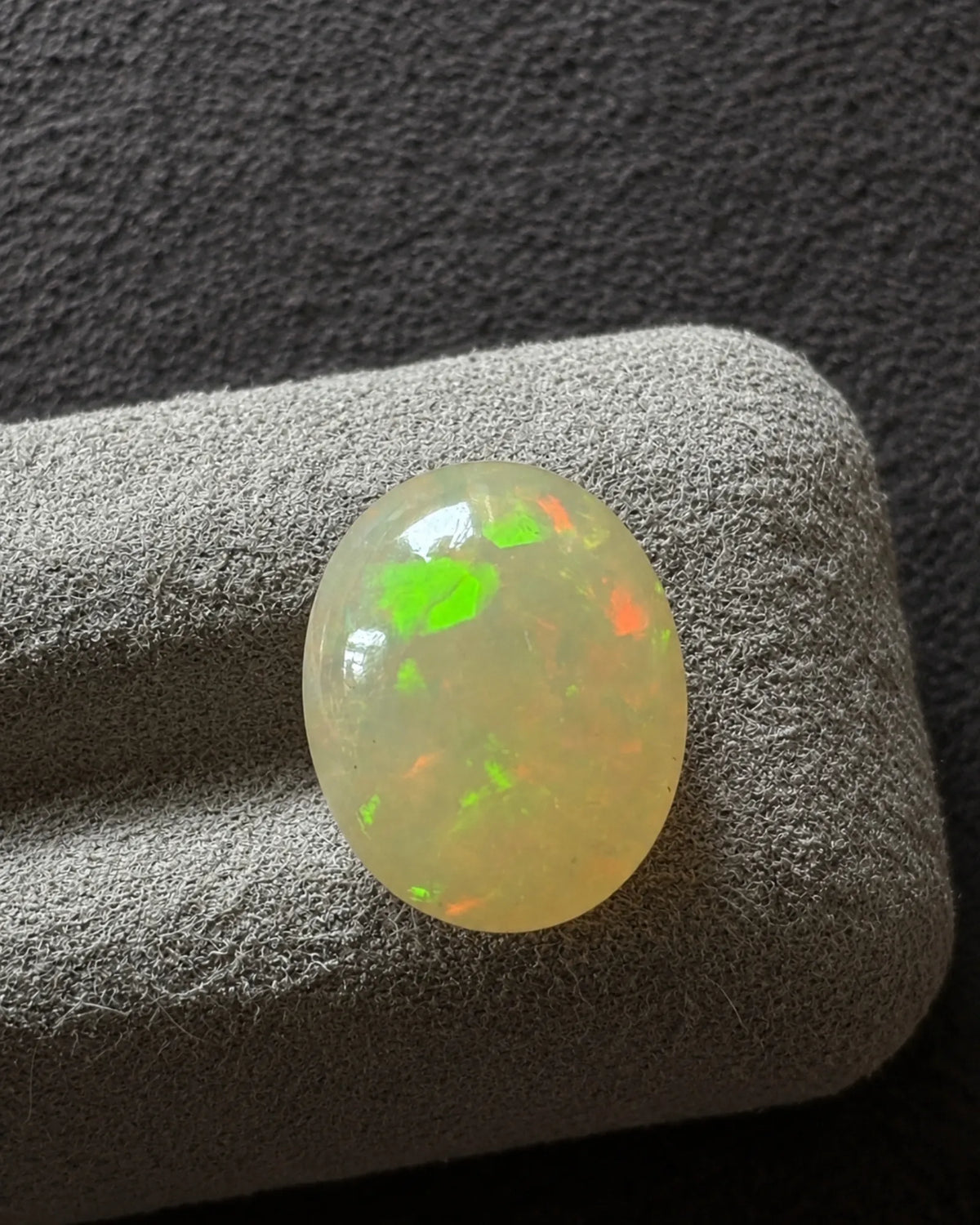 Side angle of Natural White Opal oval faceted gemstone | SARATTI
