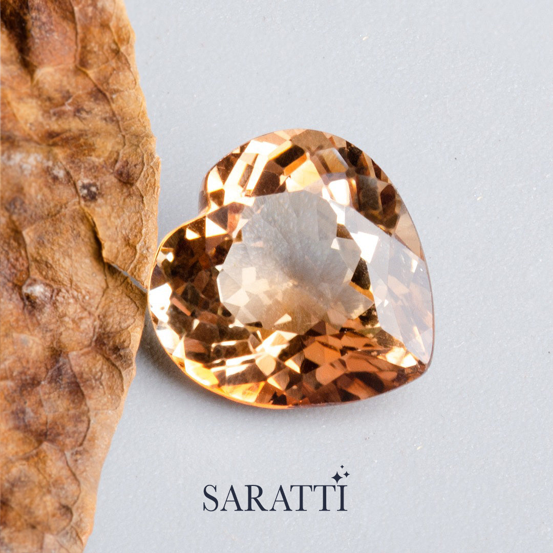 Side profile of 7.48 carat Imperial Topaz heart gemstone | SARATTI