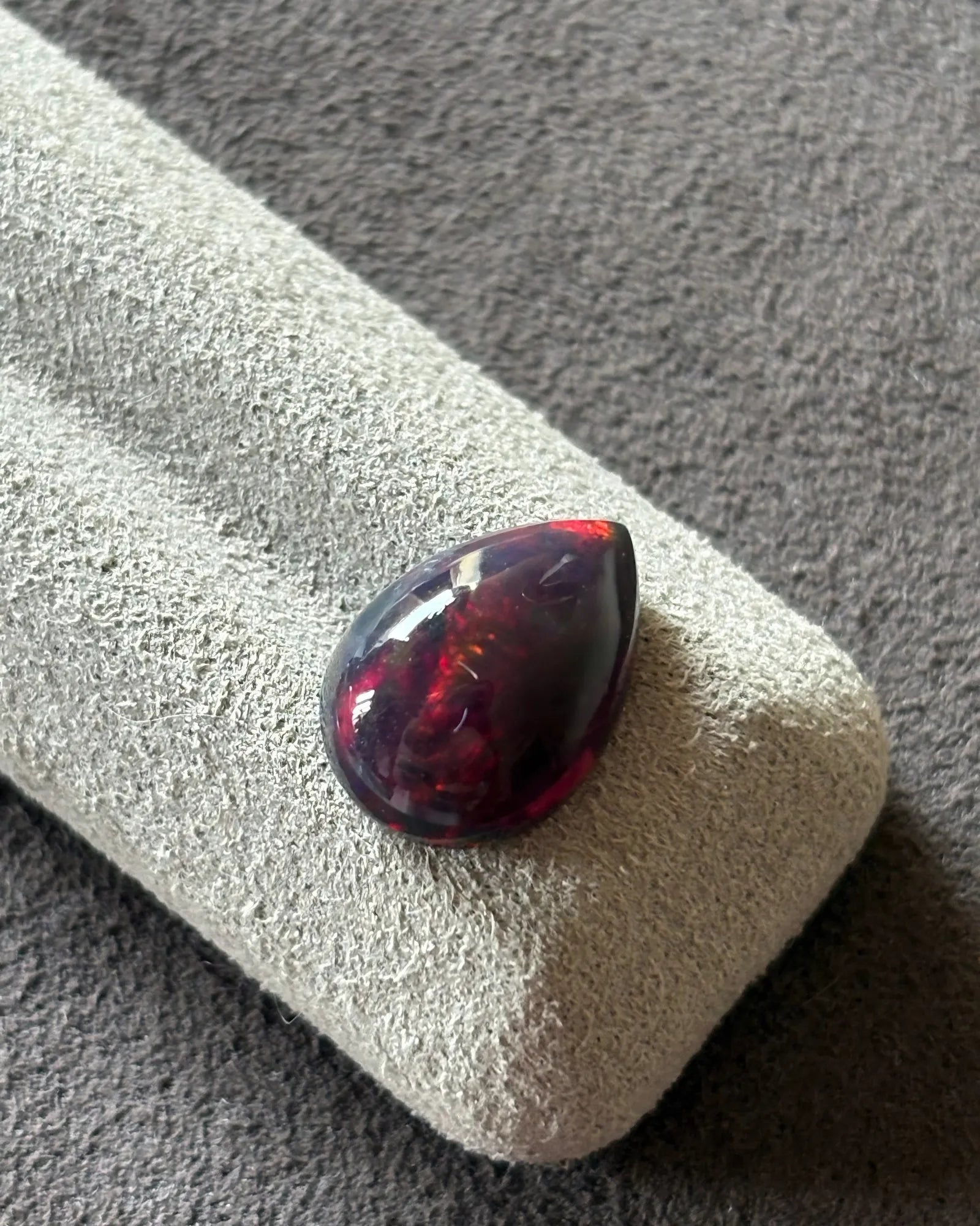 Side profile of Natural Black Opal pear cabochon with polished dome -SARATTI