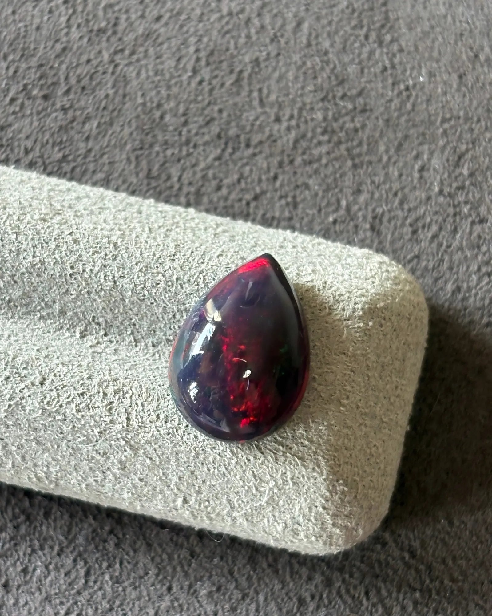 Side profile of Natural Black Opal pear cabochon with polished dome | SARATTI