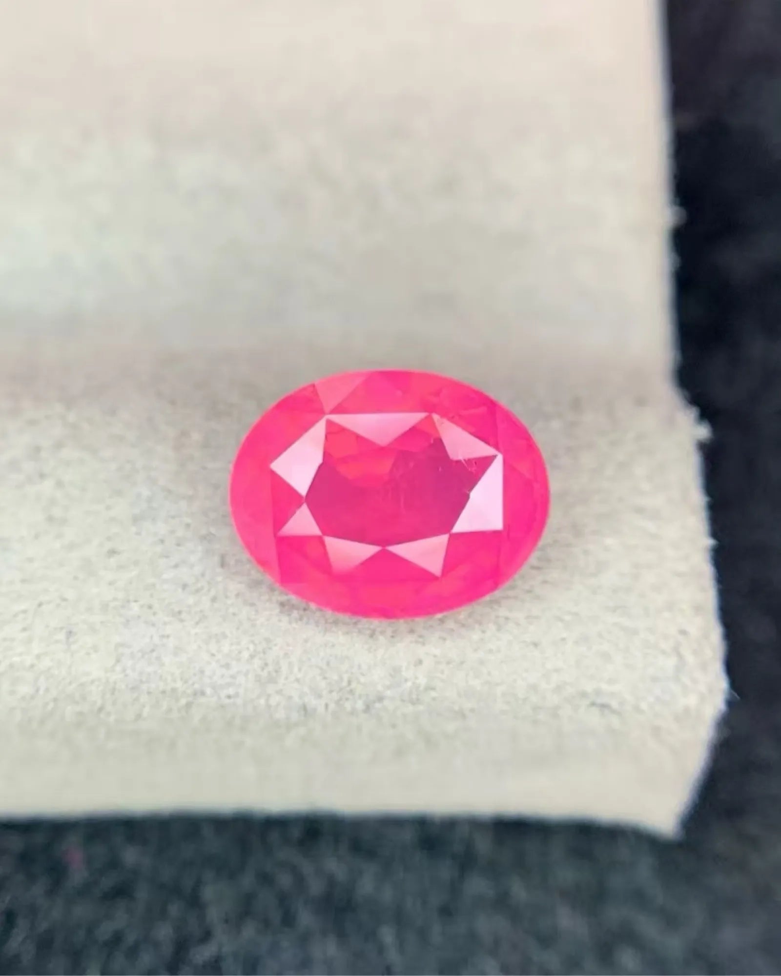 Side profile of Natural Vivid Orangy Pink Spinel oval gemstone | SARATTI