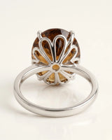 Side profile of oval Imperial Topaz ring with petal-inspired gallery in polished 18K white gold - SARATTI