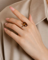 Side profile of oval Imperial Topaz ring with petal-inspired gallery in polished 18K white gold | SARATTI