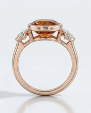 Smooth bezel setting frames the Imperial Topaz in a secure oval form in rose gold | SARATTI