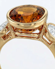 Smooth bezel setting frames the Imperial Topaz in a secure oval form in yellow gold | SARATTI