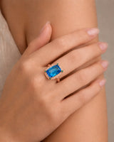 Statement blue topaz cocktail ring with green accents for milestone celebrations in 18K rose gold | SARATTI