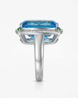 Statement blue topaz cocktail ring with green accents for milestone celebrations in 18K white gold | SARATTI