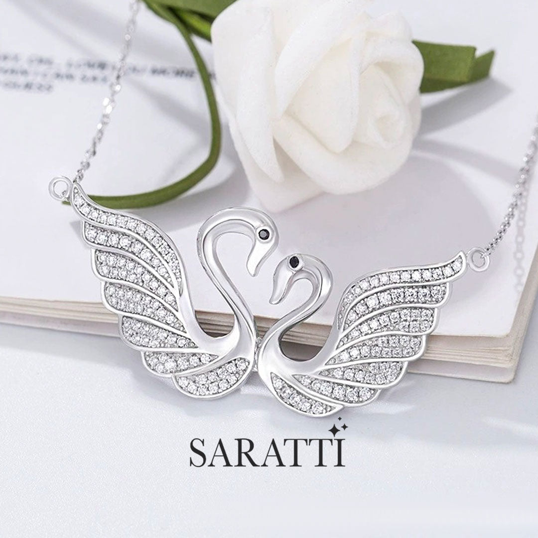 Close up shot of the pendant of the  Twin Silver Swans Pendant Necklace | Saratti 