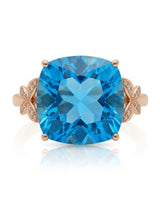 Swiss Blue cushion topaz ring with vivid color and round diamonds in 18K rose gold | SARATTI