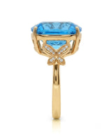 Swiss Blue cushion topaz ring with vivid color and round diamonds in 18K yellow gold | SARATTI