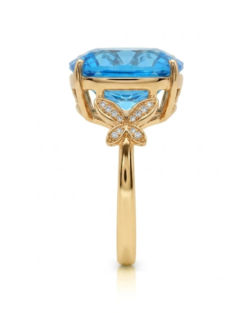 Swiss Blue cushion topaz ring with vivid color and round diamonds in 18K yellow gold | SARATTI