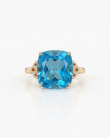Swiss Blue topaz engagement ring with romantic diamond scrollwork in 18K yellow gold | SARATTI