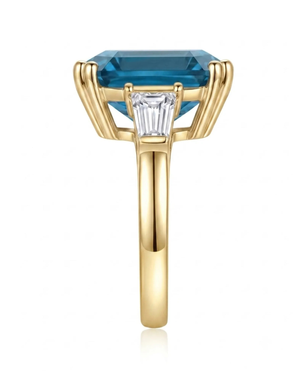 Three-stone blue topaz engagement ring with architectural baguette accents in 18K yellow gold | SARATTI