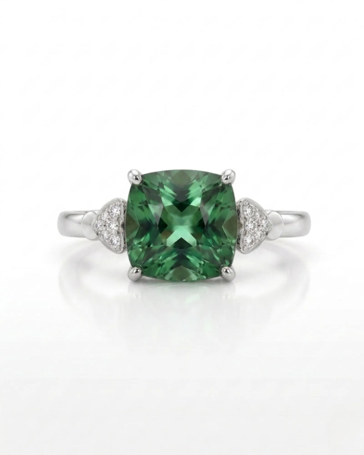 Three-stone green tourmaline ring with diamond heart pavilions and 18K white gold setting | SARATTI