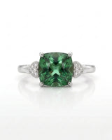 Three-stone green tourmaline ring with diamond heart pavilions and 18K white gold setting | SARATTI