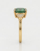 Three-stone green tourmaline ring with diamond heart pavilions and 18K yellow gold setting | SARATTI