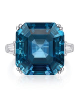 Three-stone topaz engagement ring with geometric step facets and baguette diamonds in platinum | SARATTI