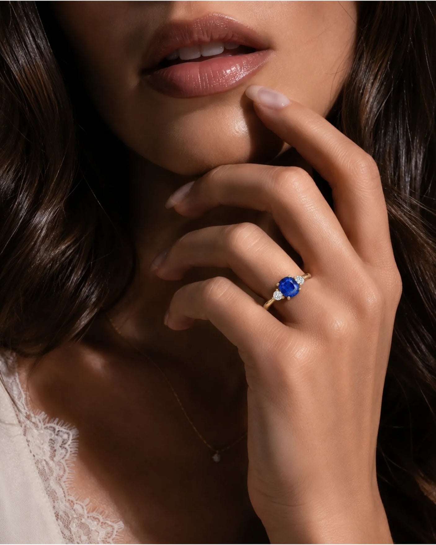 Three stone sapphire ring with round diamond accents in warm yellow gold | SARATTI