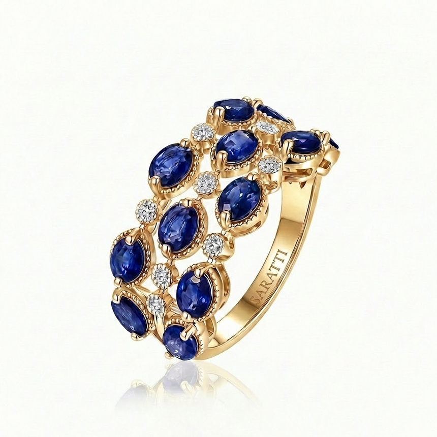 Gold ring with blue gemstones and diamonds on a white background -Trame Bleue blue sapphire and diamond ring in 18K yellow gold | SARATTI