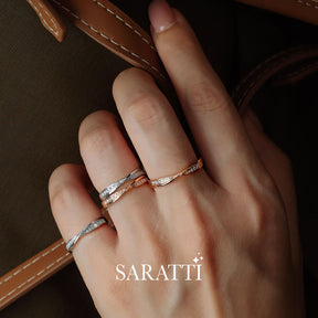 Model holds bag while displaying White and Rose Gold Twisted Shank Diamond Eternity Wedding Bands | Saratti