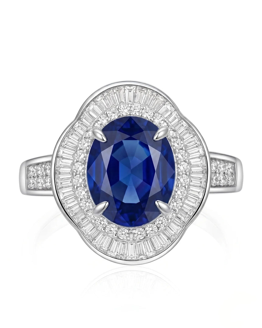 Unheated oval sapphire ring with tapered baguette diamonds and royal blue center in platinum | SARATTI