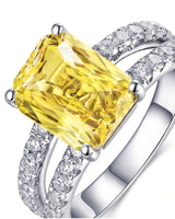 Unheated radiant yellow sapphire ring framed by round brilliant diamonds in platinum | SARATTI