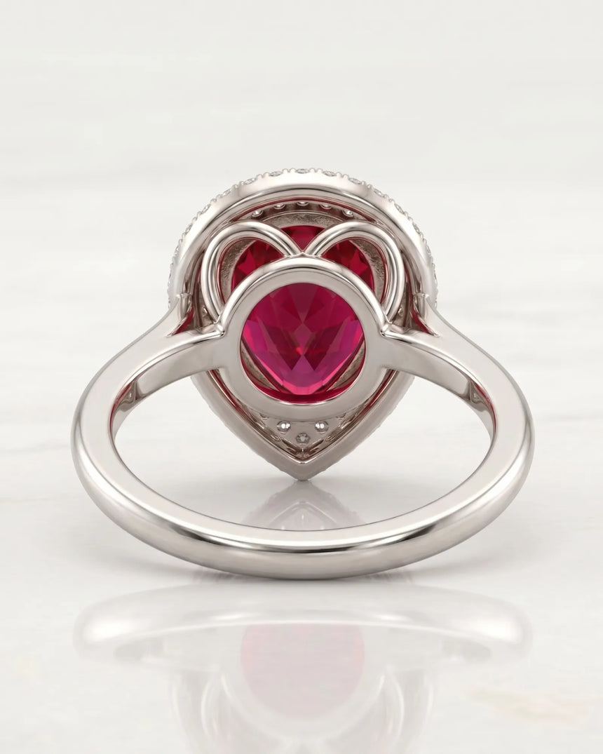 Vibrant red-pink pear tourmaline ring framed by diamonds in platinum | SARATTI