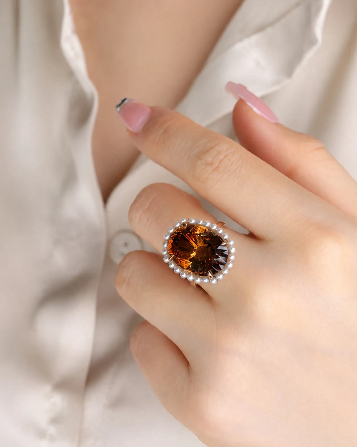 Vintage-inspired pearl halo ring showcasing an oval Imperial Topaz in warm 18K yellow gold | SARATTI