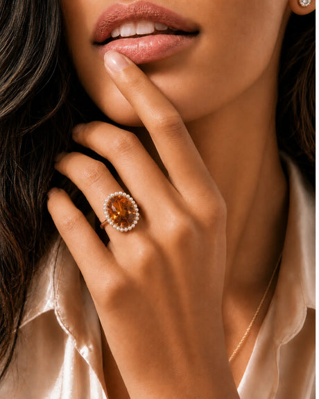 Vintage-inspired pearl halo ring showcasing an oval Imperial Topaz in warm 18K yellow gold | SARATTI