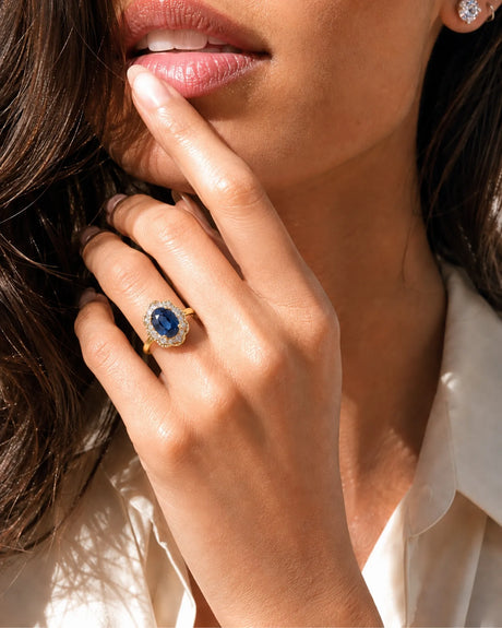 Vintage-inspired sapphire ring with floral diamond halo in warm yellow gold | SARATTI