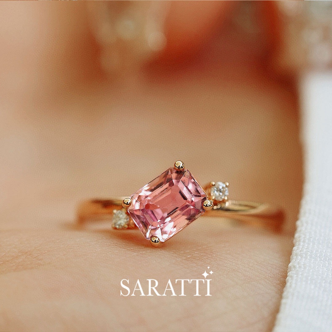 Pink Emerald Cut Tourmaline in focus | Model holds the Sakura Trilogy Tourmaline and Diamond Ring | Saratti Fine Jewelry 