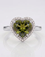 Vivid green heart tourmaline ring framed by natural diamonds in platinum | SARATTI