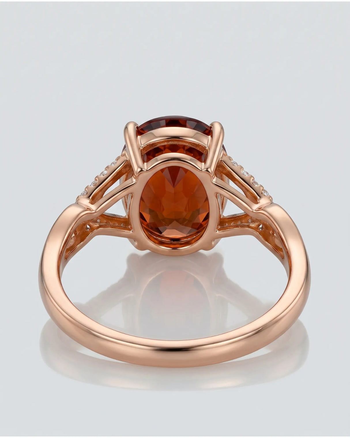 Vivid orange oval garnet ring with natural diamond shoulders in 18K rose gold | SARATTI